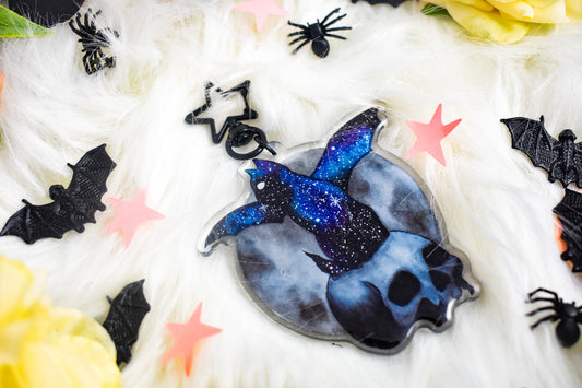 Decorative skull with a cat with bats wings with a starry design on a white background with spider decorations