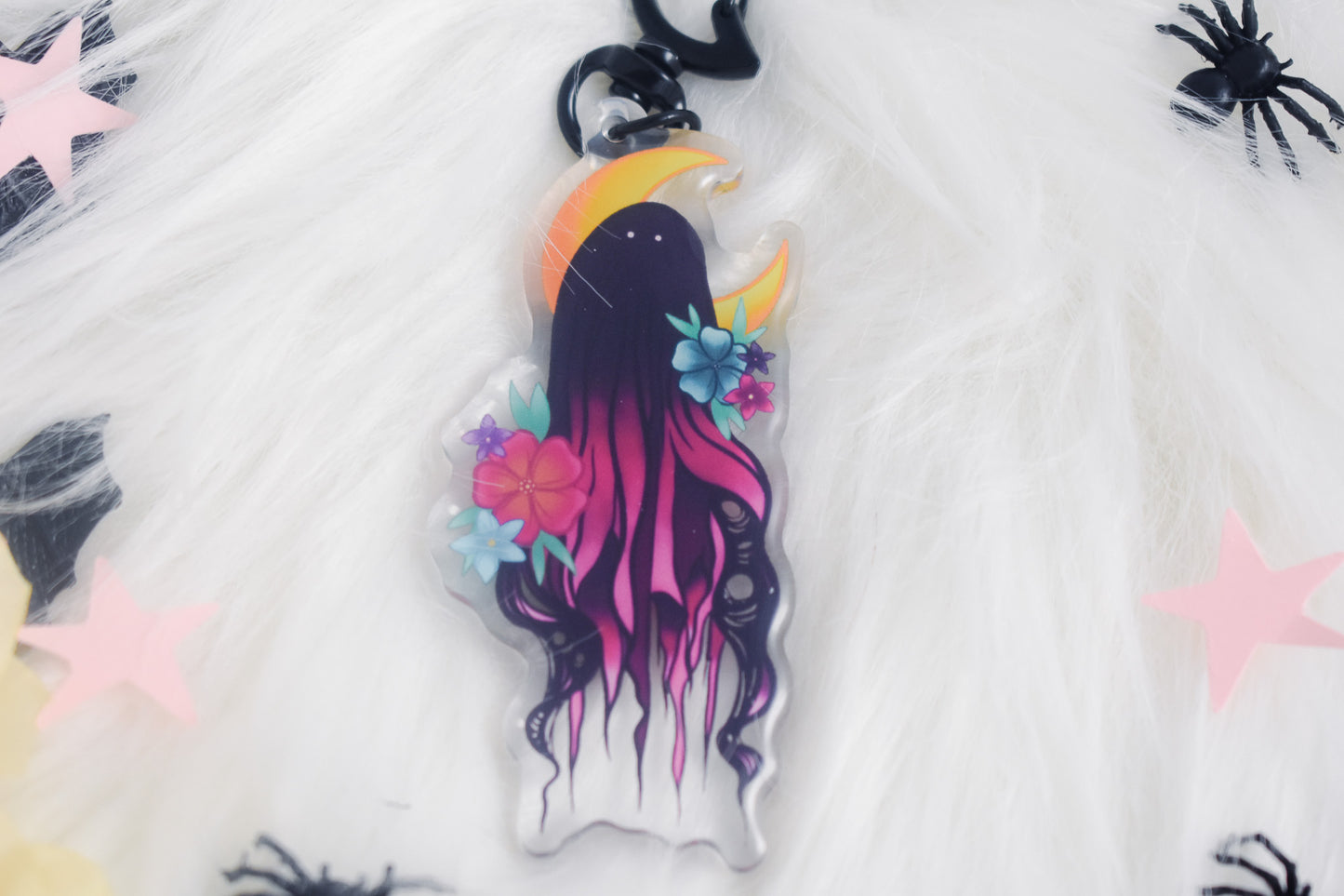 Decorative keychain with a stylized ghost design on a white background
