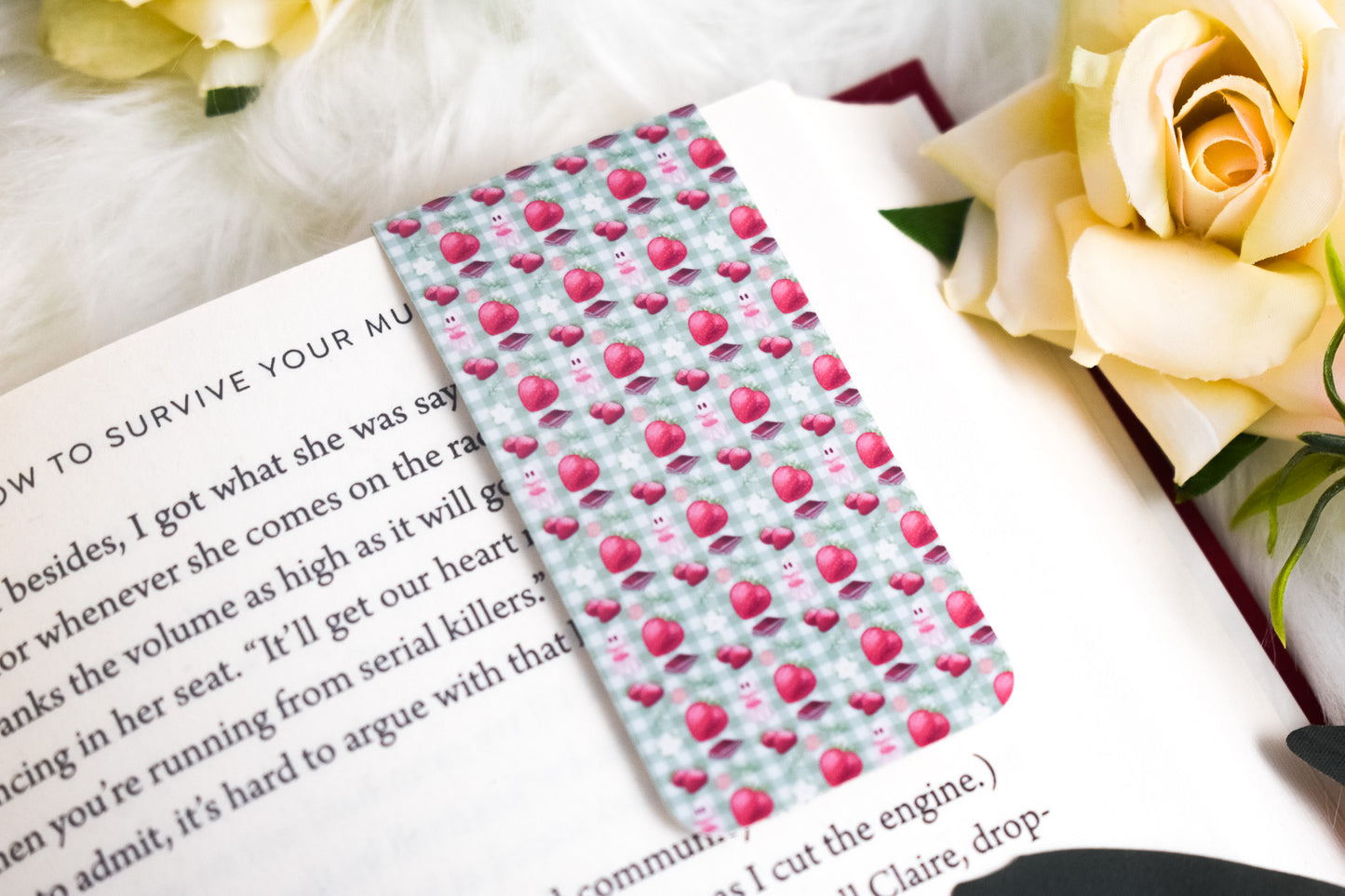 Bookmark with ghosts and strawberries on a book with flowers