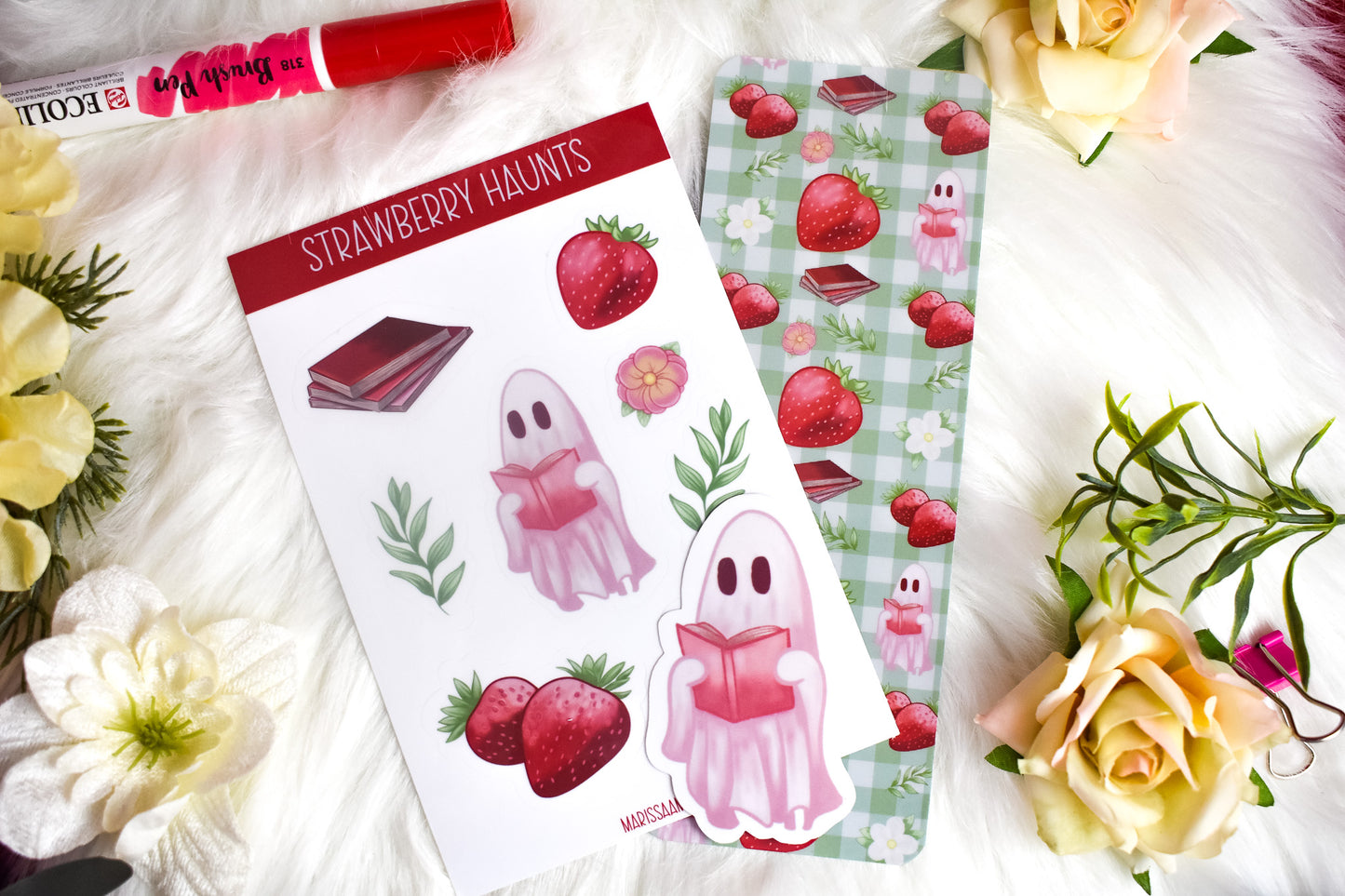 Sticker sheet, die-cut sticker and bookmark with strawberry-themed designs on a floral background