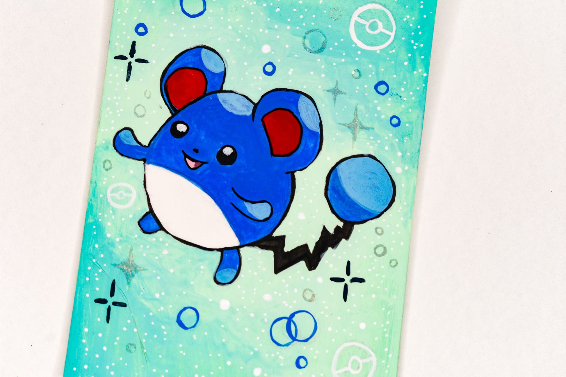 Cartoon blue creature with red cheeks on a light green background with bubbles