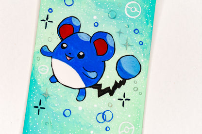 Cartoon blue creature with red cheeks on a light green background with bubbles
