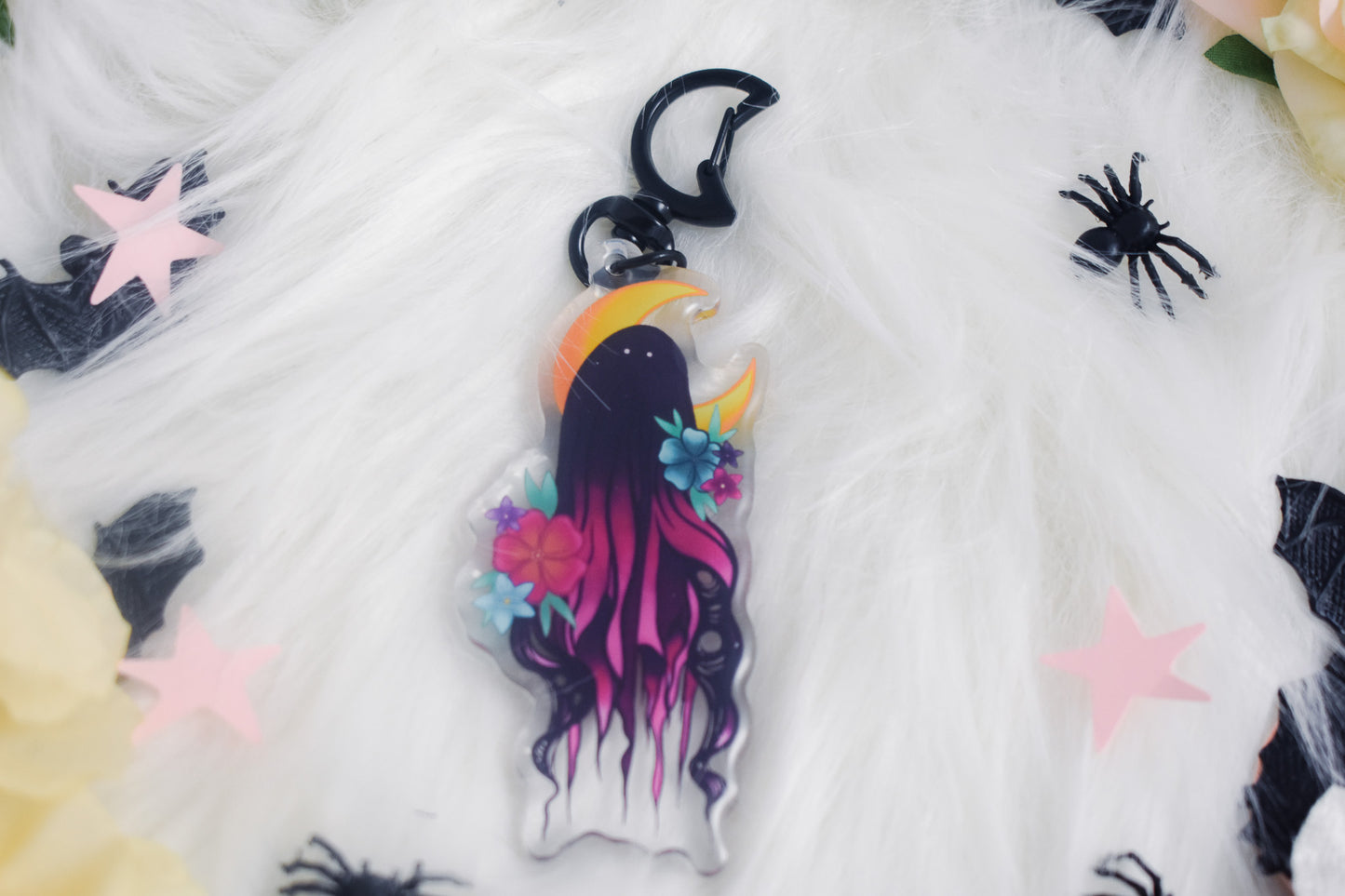 Keychain with a colorful design of a ghost on a white fabric background.