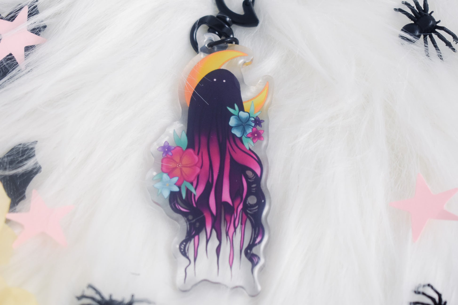 Decorative keychain with a stylized ghost design on a white background