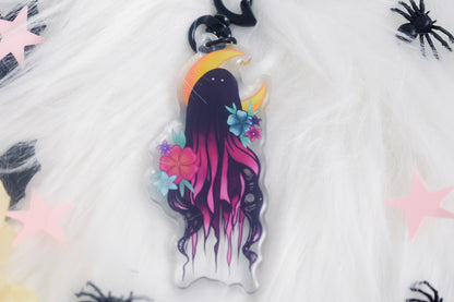 Decorative keychain with a stylized ghost design on a white background
