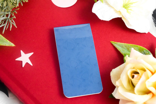 Blue bookmark on a book with a rose in the background
