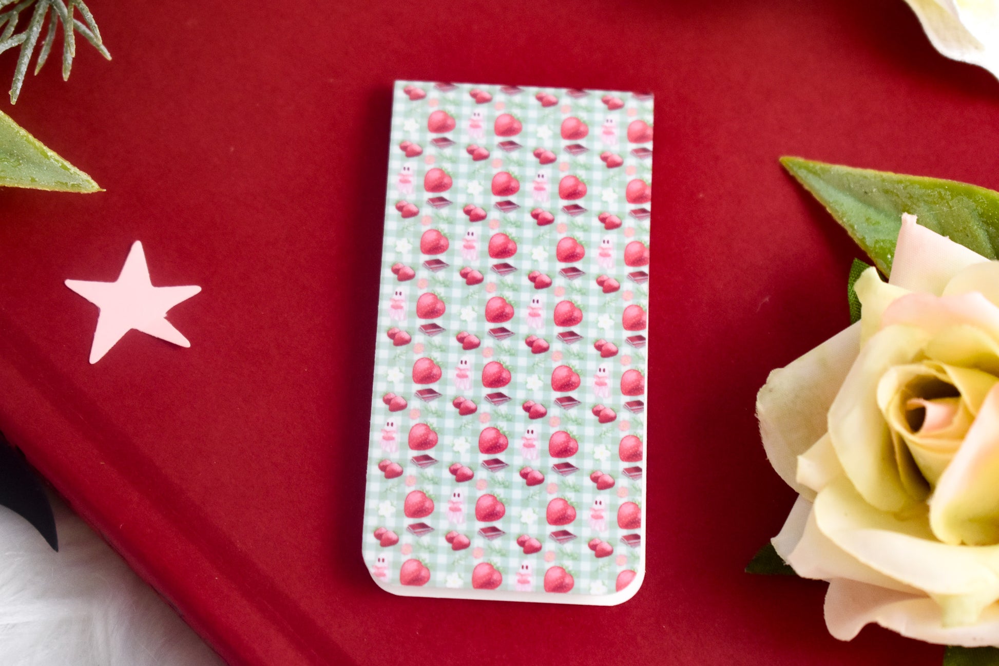 Patterned bookmark on a red book with a star and rose