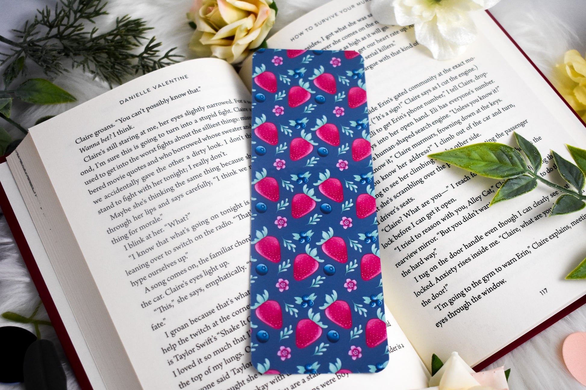 Floral patterned bookmark on an open book with flowers and leaves around