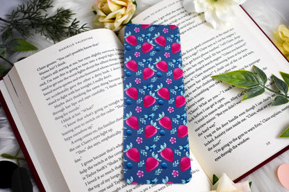 Floral patterned bookmark on an open book with flowers and leaves around