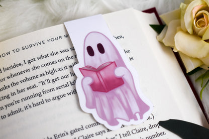 Ghost holding a book on an open book with yellow roses in the background