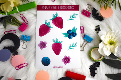 Sheet of 'Berry Sweet Blossoms' stickers surrounded by decorative items on a textured surface