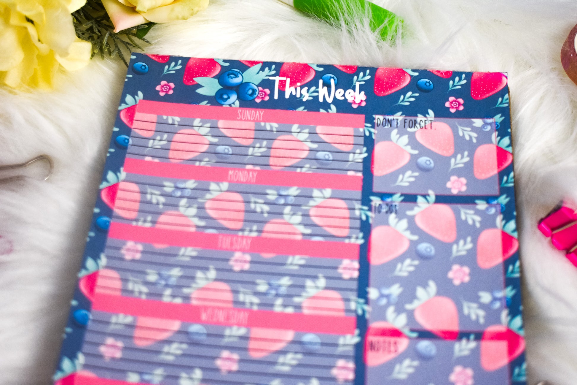 Weekly planner with strawberry designs on a floral background