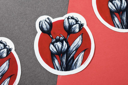 Sticker with black and white tulip design on a red and gray background